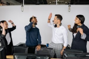 Employees high-fiving after success